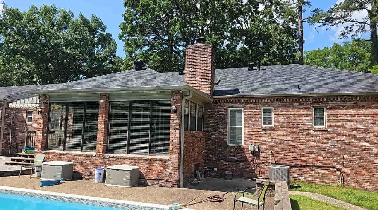 Brick ranch home with a pool and a new asphalt shingle roof