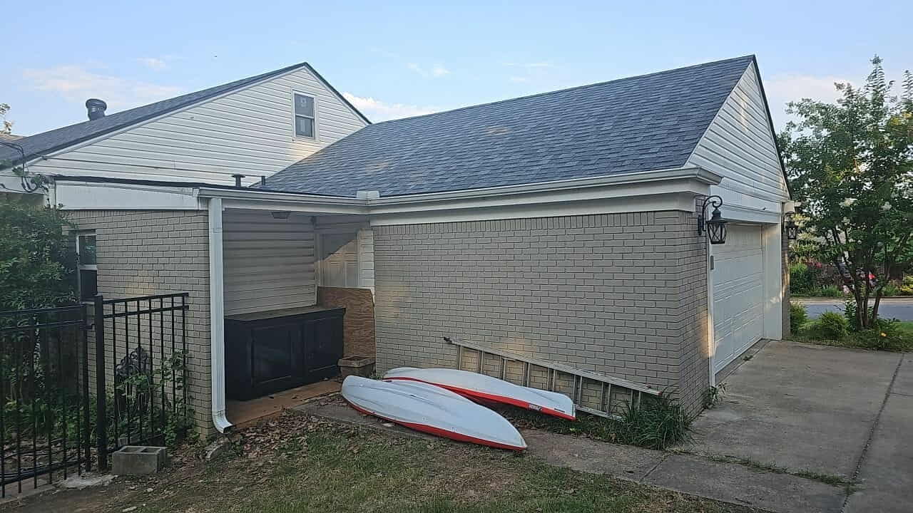 Completed roof replacement on a home with grey siding