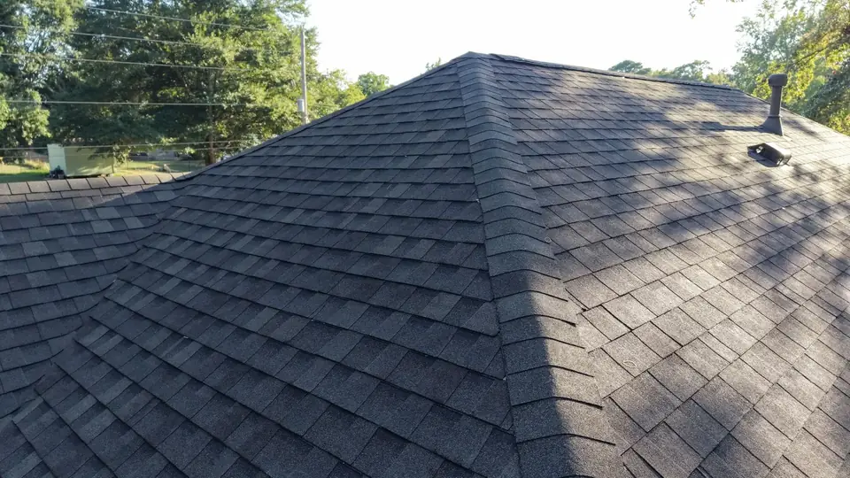 Dark architectural shingles on a newly replaced hip roof in Benton
