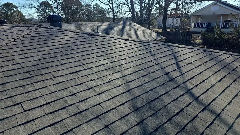 New dark shingles and turbine vents on a replaced roof in Hot Springs