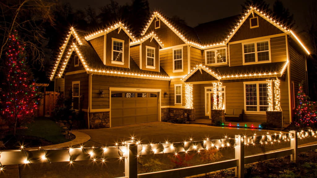 House decorated with bright holiday lights at night