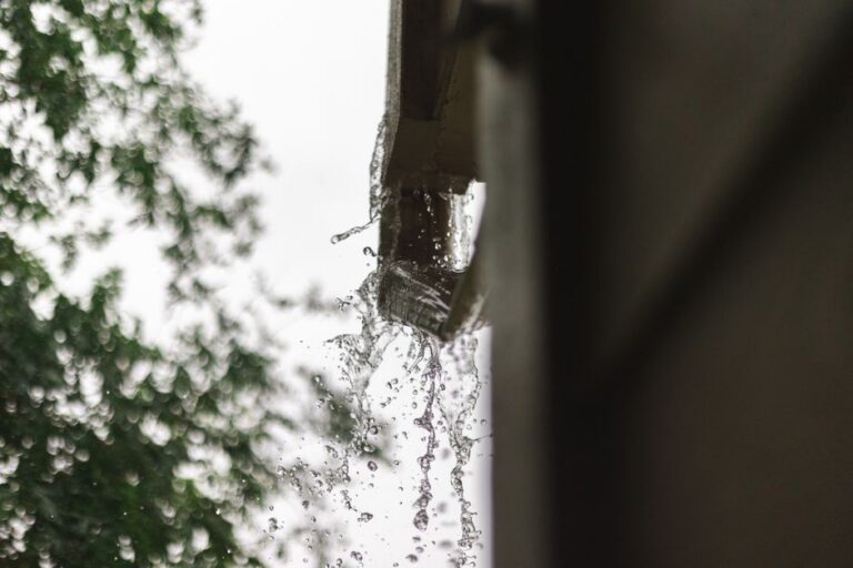Arkansas storm rainfall overflowing gutters on residential home