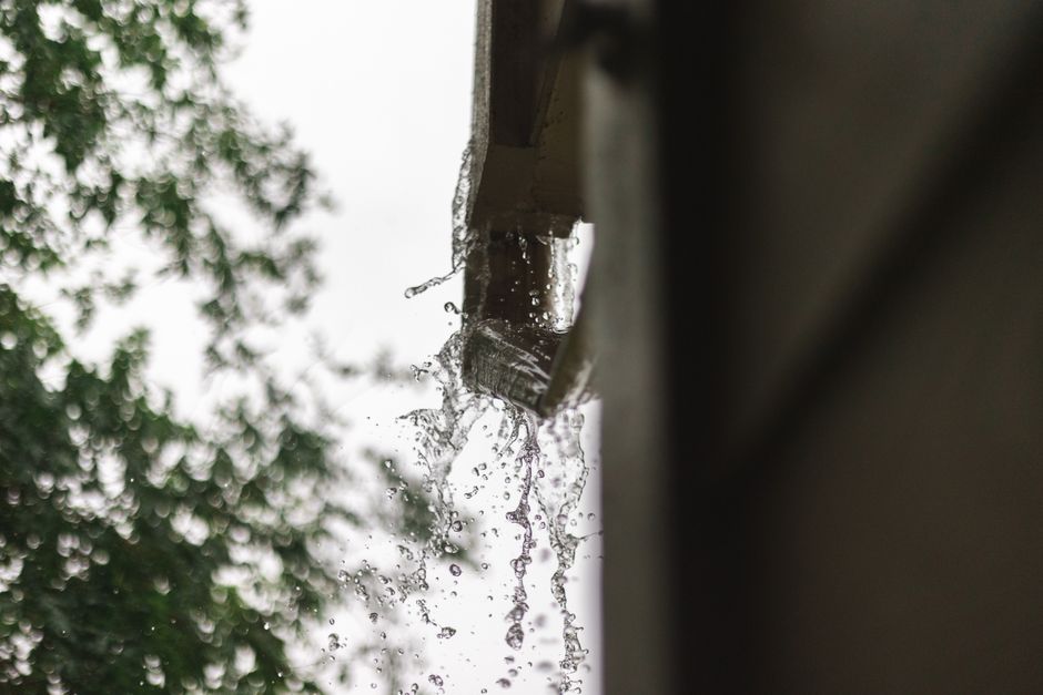 Arkansas storm rainfall overflowing gutters on residential home
