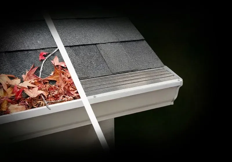 Gutter guard being fitted over a gutter full of leaves
