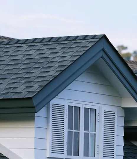 Gable end with shutters and a shingle roof