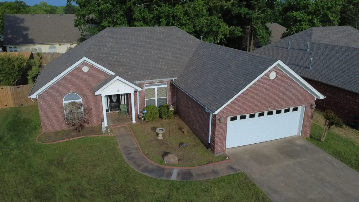 Single-storey brick home before a roof replacement