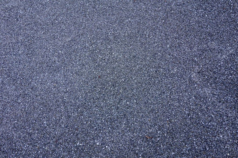 aging asphalt shingles showing severe granule loss and wear aging asphalt shingles showing severe granule loss and wear