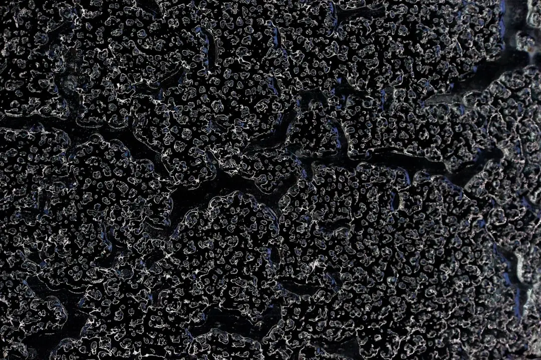 Sun-damaged asphalt shingles showing severe granule loss and curling Sun-damaged asphalt shingles showing severe granule loss and curling