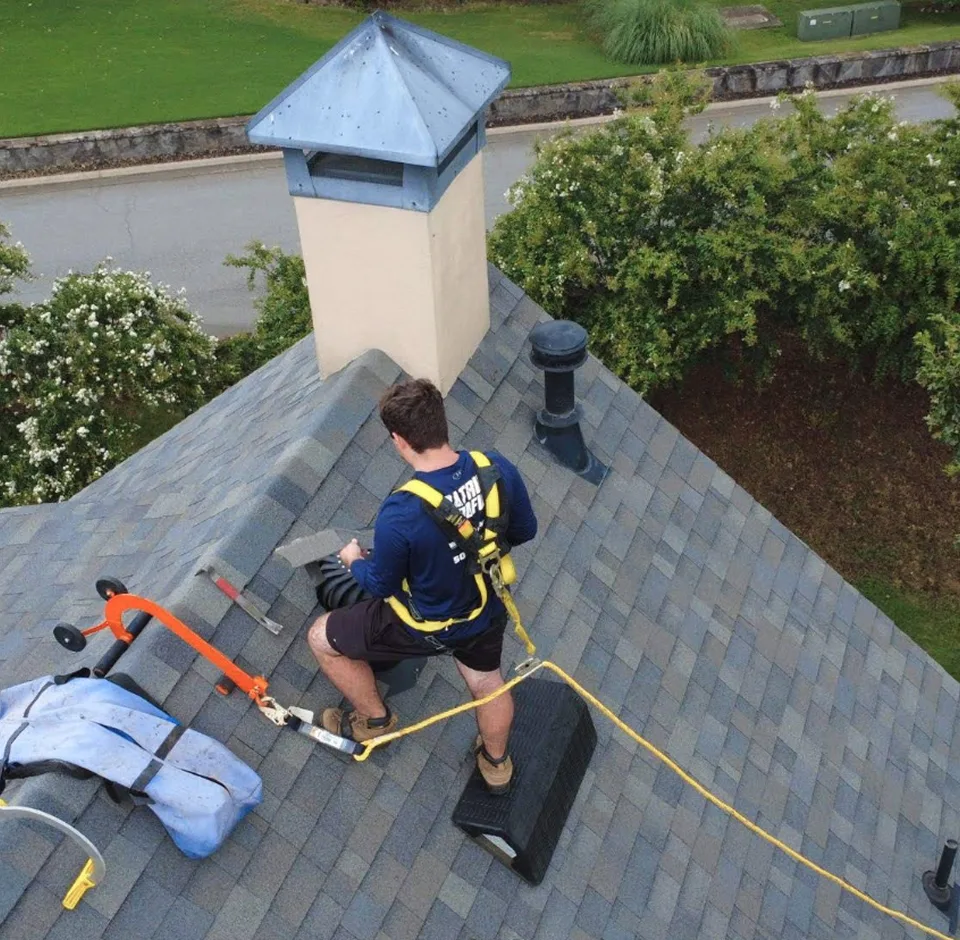 Roofer working on a roof with a skylight