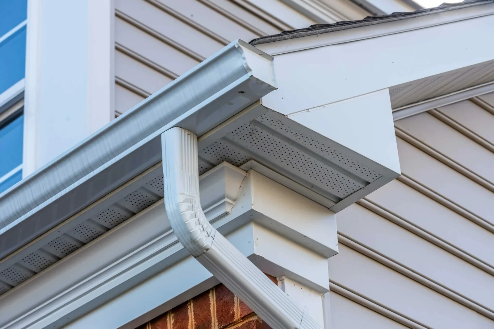White seamless gutter and downspout on a home
