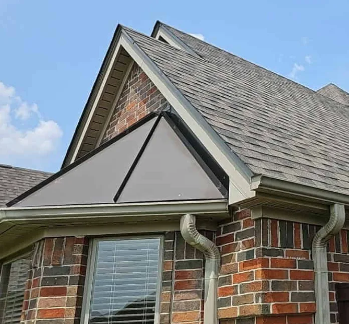 Brick and siding home with a steep shingle roof