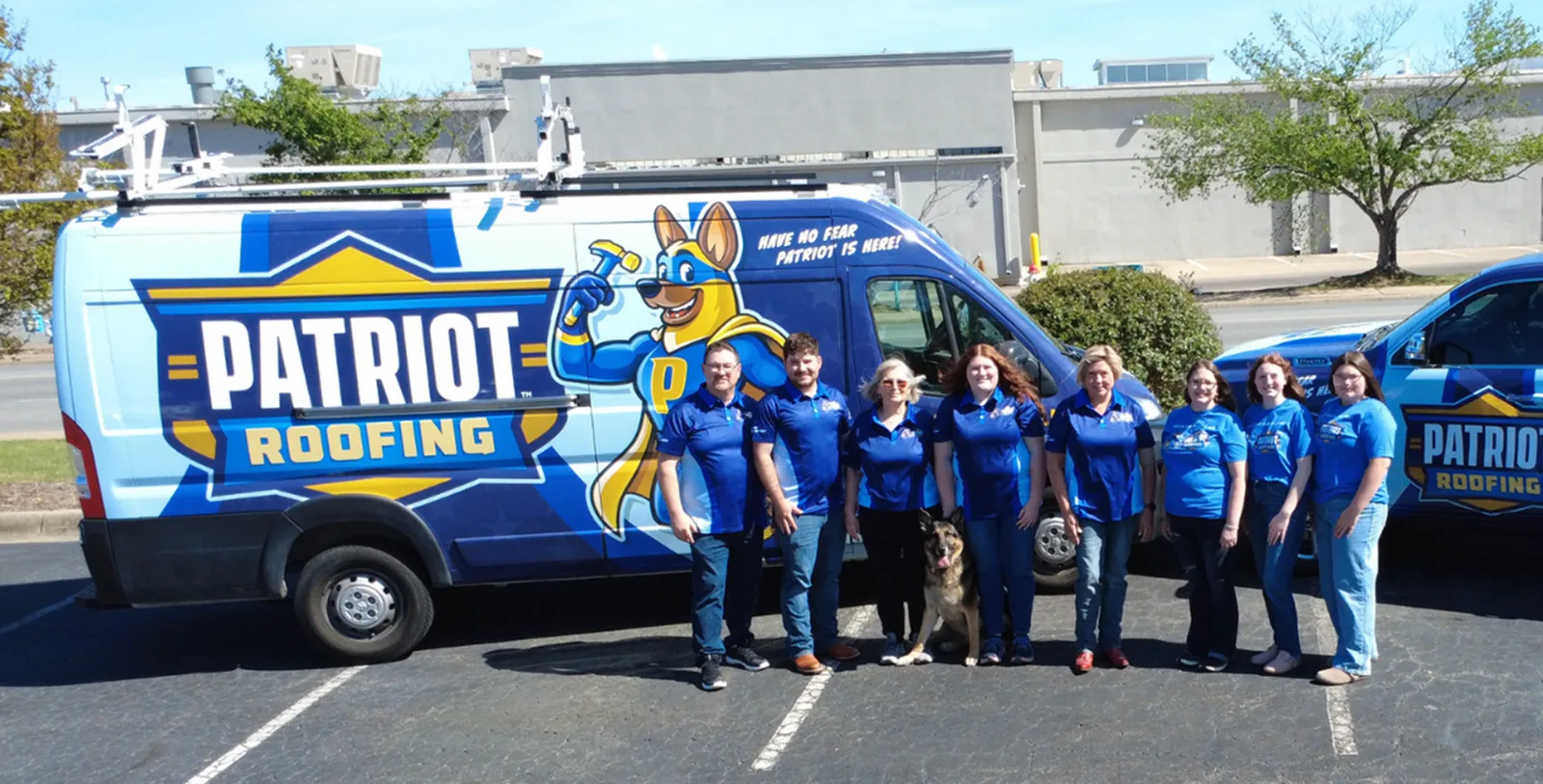 Patriot Roofing crew standing with the branded service vans