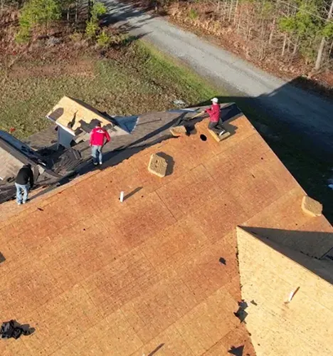 Roofers working on an exposed roof deck