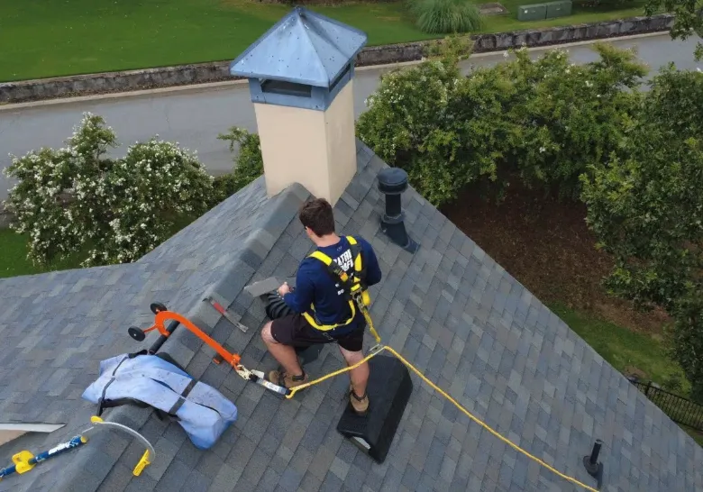 Roofers installing shingles on a residential roof