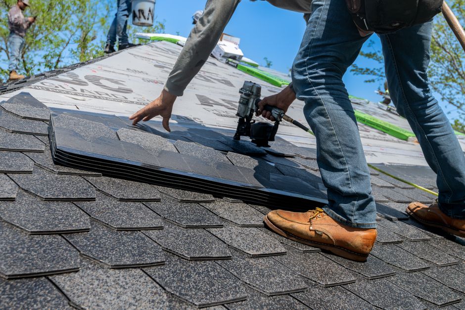 Professional roof inspection checking shingles and underlayment Professional roof inspection checking shingles and underlayment